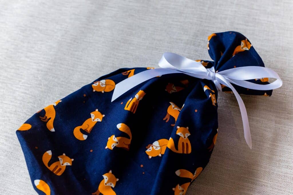 Small fabric gift bag, cute foxes on a navy blue background