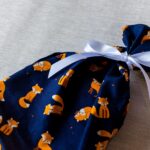 Small fabric gift bag, cute foxes on a navy blue background