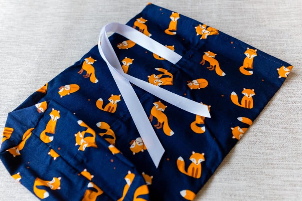 Small fabric gift bag, cute foxes on a navy blue background