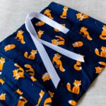 Small fabric gift bag, cute foxes on a navy blue background