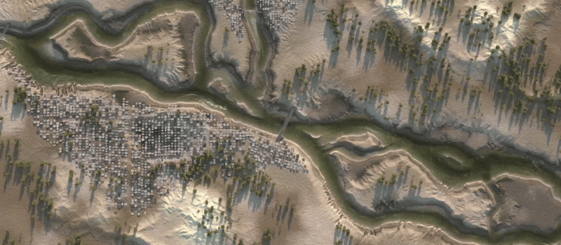 Aerial satellite view of a river flowing through a dry landscape and a small town.