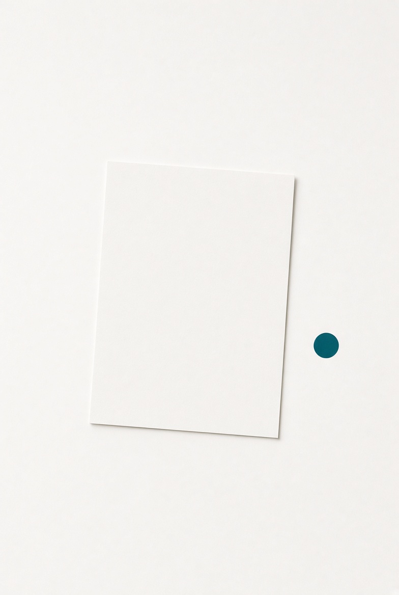 One sheet of paper with a single teal mark and generous empty space