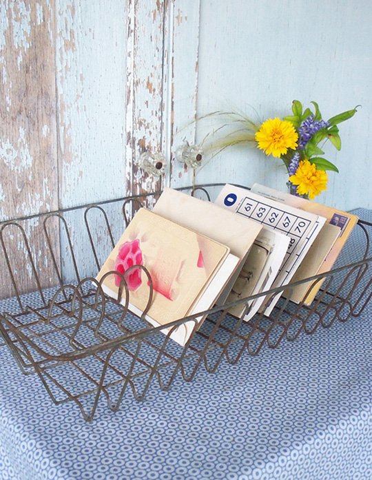 Vintage dish rack holding mail and other paper ephemera.