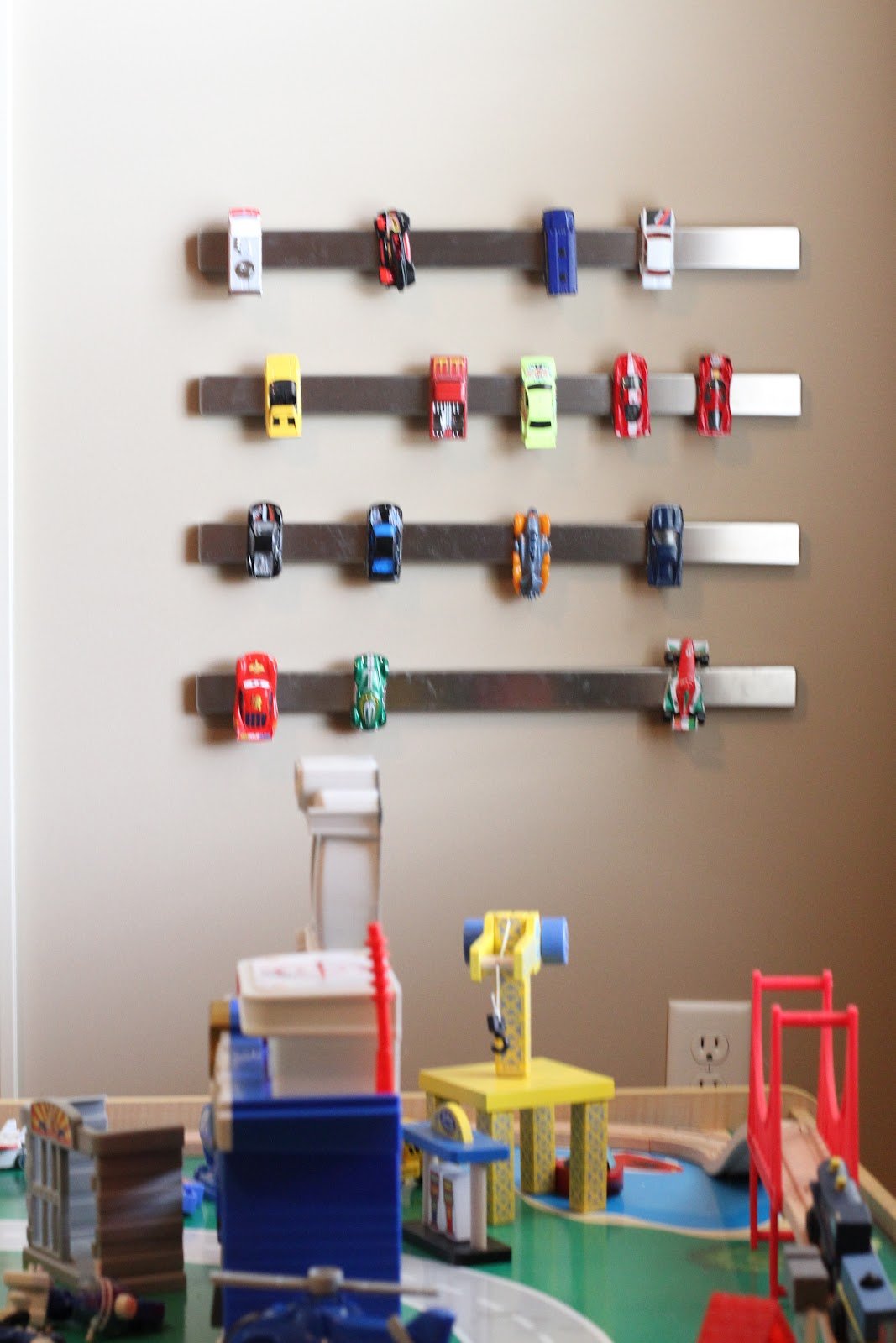 Matchbox car storage using old magnetized knife holders on the wall of a kids room.