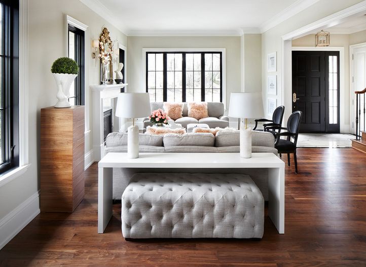 console table with chairs behind couch