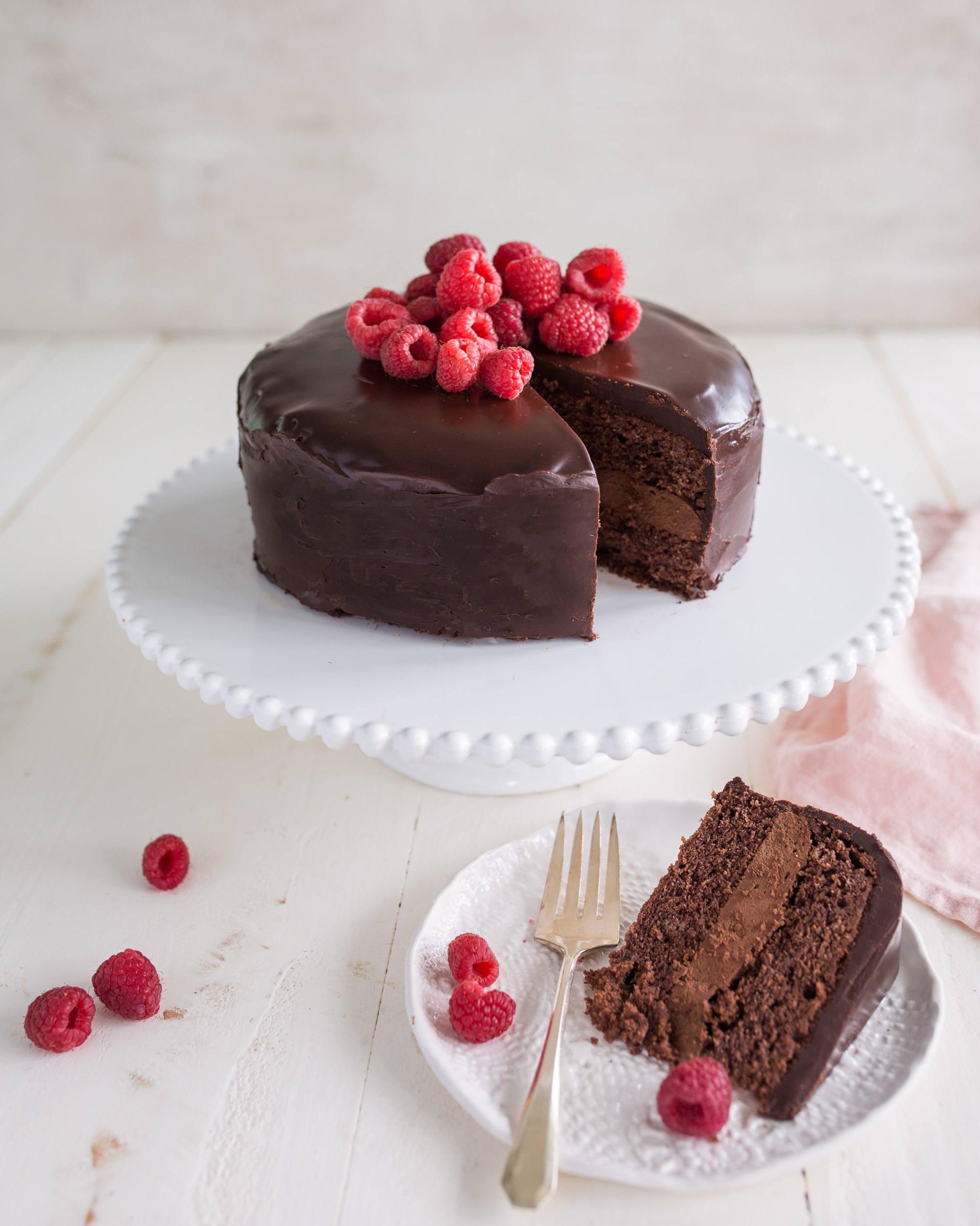 Two small chocolate covered sponge cakes on a white background. | CanStock