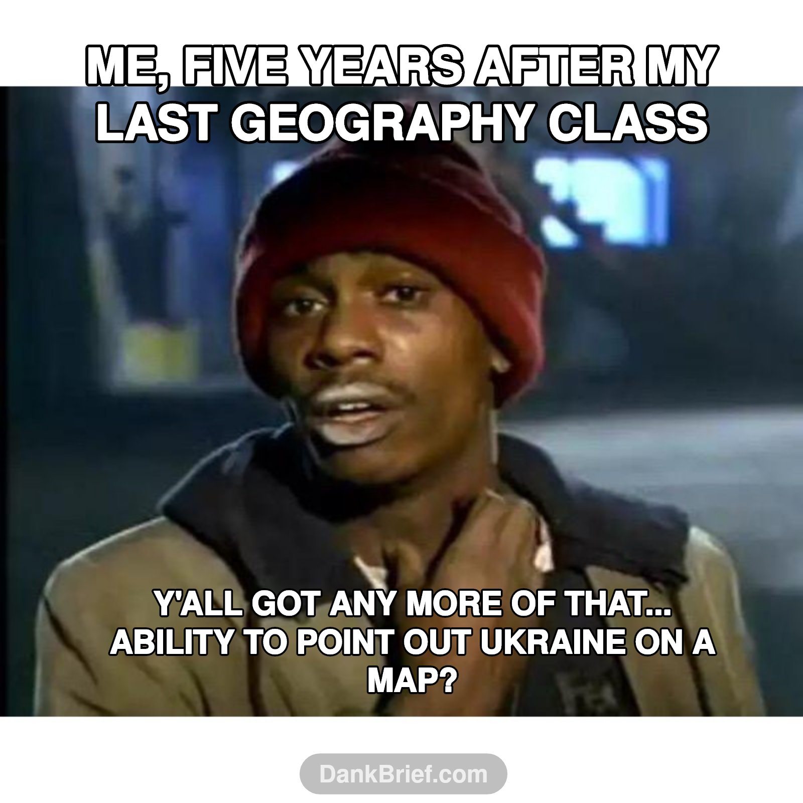 Me after graduation looking at a globe