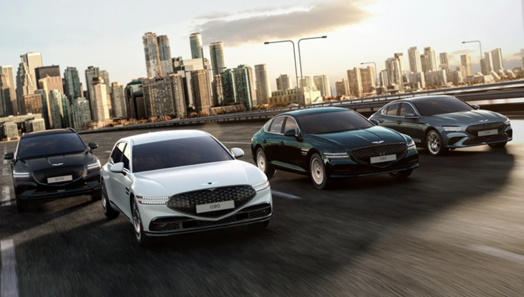Genesis vehicles lineup on road with mountain backdrop