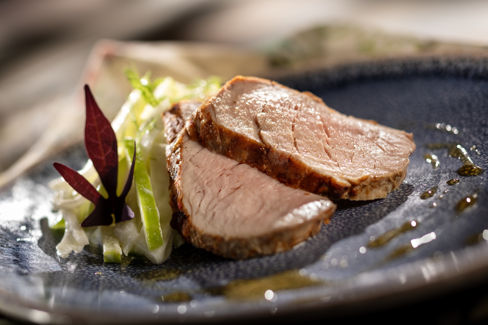 Grilled Cider-brined Pork Tenderloin, with chili-apple butter, celeriac-apple slaw, and apple cider gastrique, served at Bramblewood Bites during the 2026 EPCOT International Food and Wine Festival