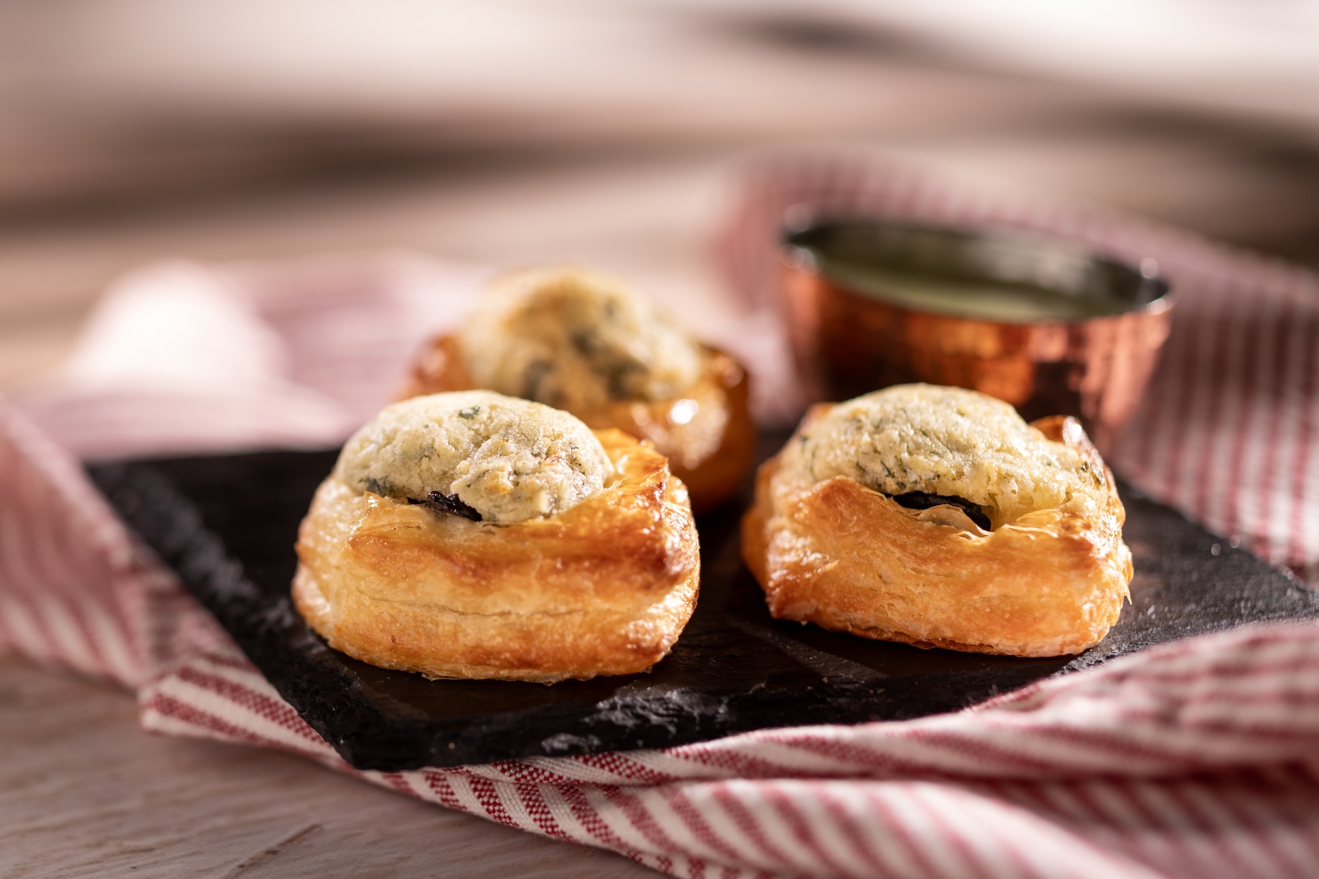Trio d'Escargots, Garniture a l'ail et au Persil, Trio of escargot bites in croissant dough served with a garlic-parsley dip (Introduced in 1996), served at France during the 2026 EPCOT International Food and Wine Festival
