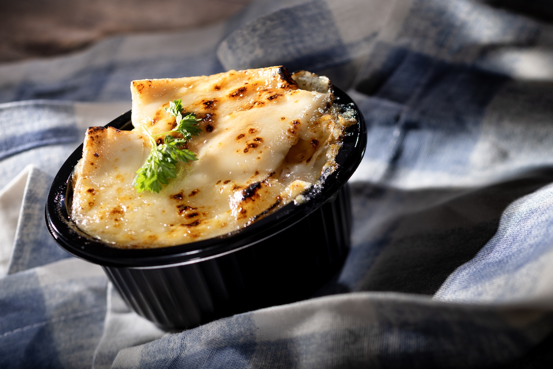 Tartiflette, Potatoes gratin, caramelized onions, bacon, thyme, crème fraîche, and brie, served at The Alps during the 2026 EPCOT International Food and Wine Festival