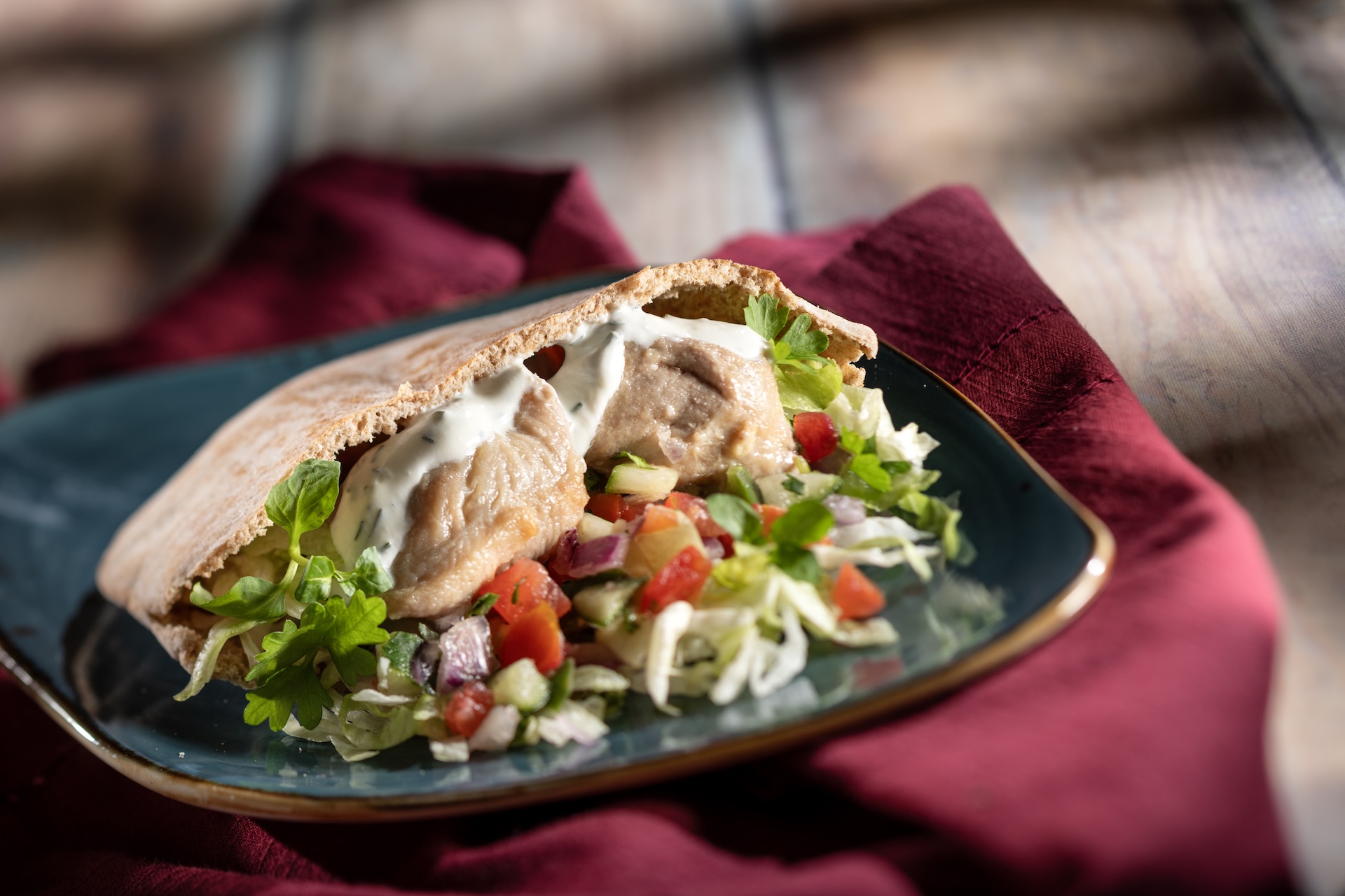 Chicken Souvlaki Gyro, with shaved lettuce, tomato-cucumber relish, and tzatziki on warm pita (Introduced in 1997), served at Greece during the 2026 EPCOT International Food and Wine Festival