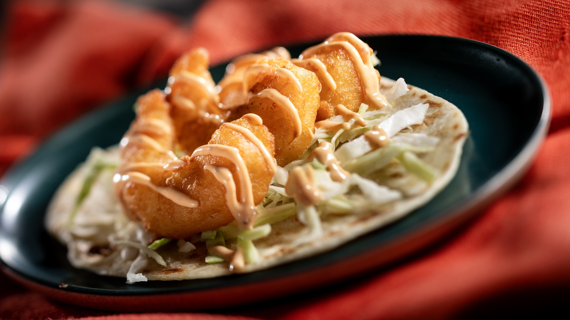 Taco de Camaron, Flour tortilla with crispy tempura shrimp, shredded cabbage, and chipotle aïoli (Introduced in 2010), served at Mexico during the 2026 EPCOT International Food and Wine Festival