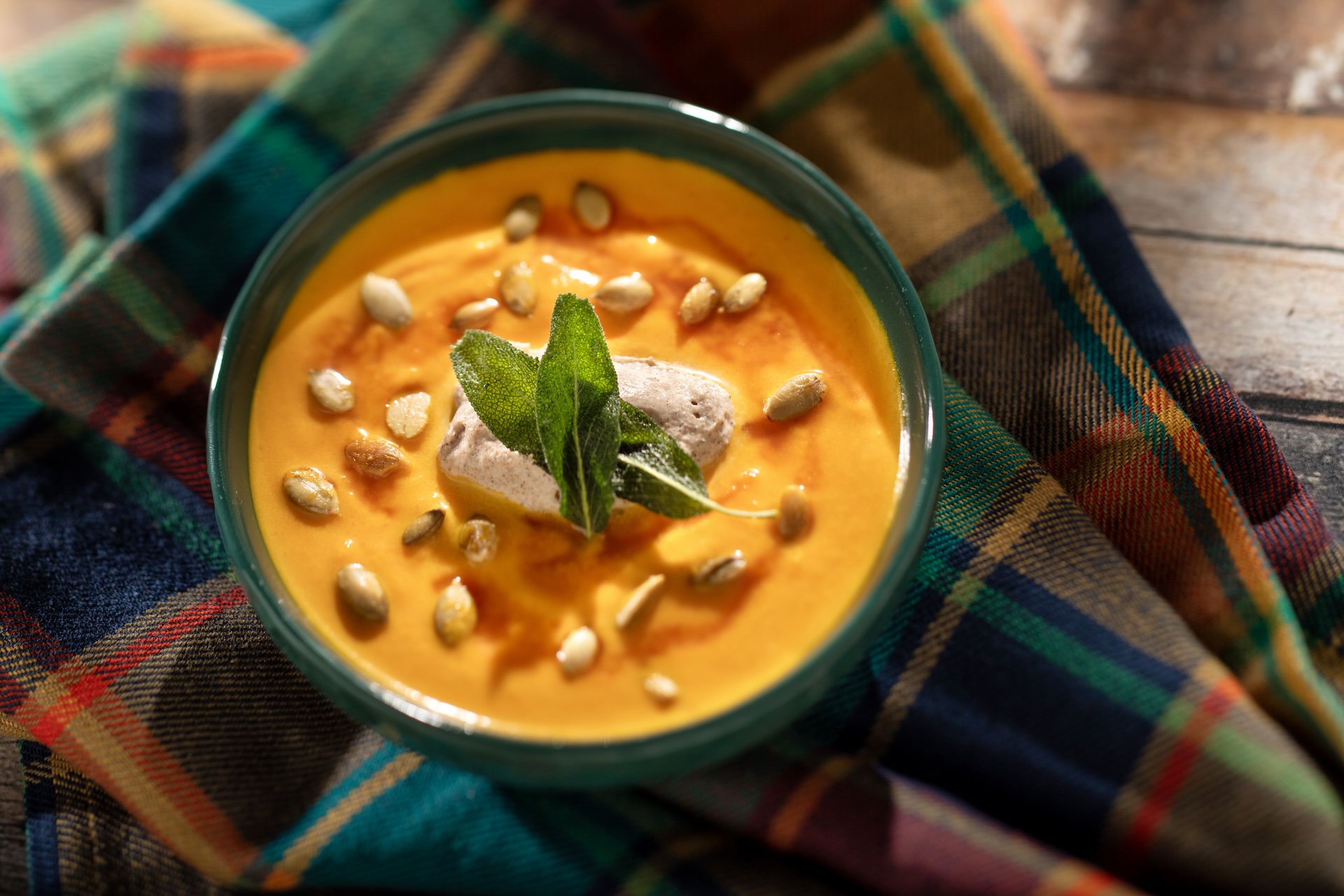 Butternut Squash and Ginger Bisque, with cinnamon cream, toasted pumpkin seeds, and pumpkin seed oil, served at Milled & Mulled during the 2026 EPCOT International Food and Wine Festival