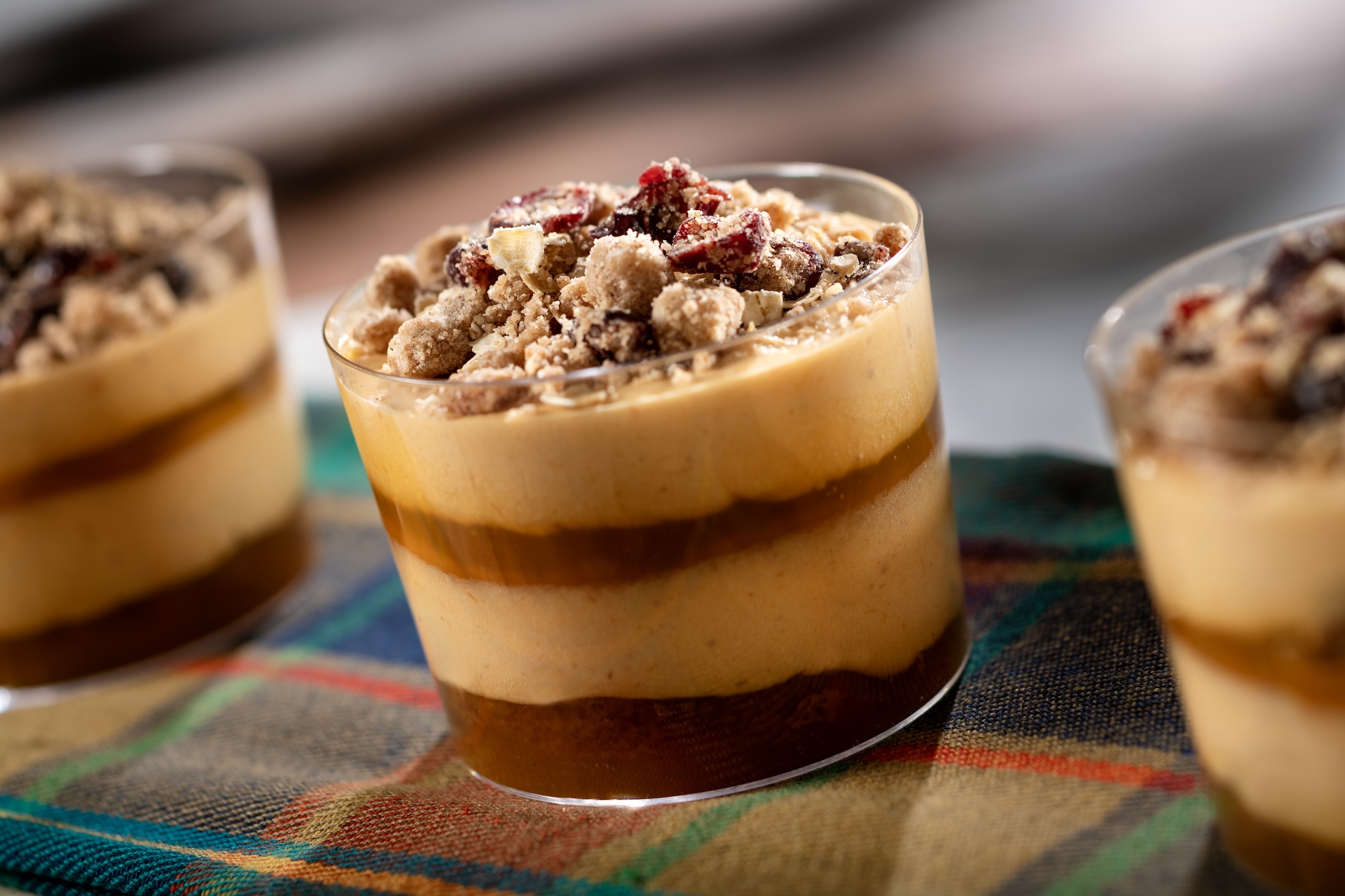 Pumpkin Cheesecake Mousse Trifle, featuring PHILADELPHIA Cream Cheese with citrus sauce and spice cake topped with cranberry streusel (Introduced in 2011 at Hops & Barley), served at Festival Favorites during the 2026 EPCOT International Food and Wine Festival