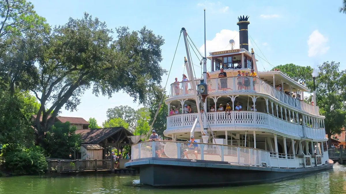 The Liberty Belle riverboat sailing past Tom Sawyer Island on Rivers of America at Magic Kingdom