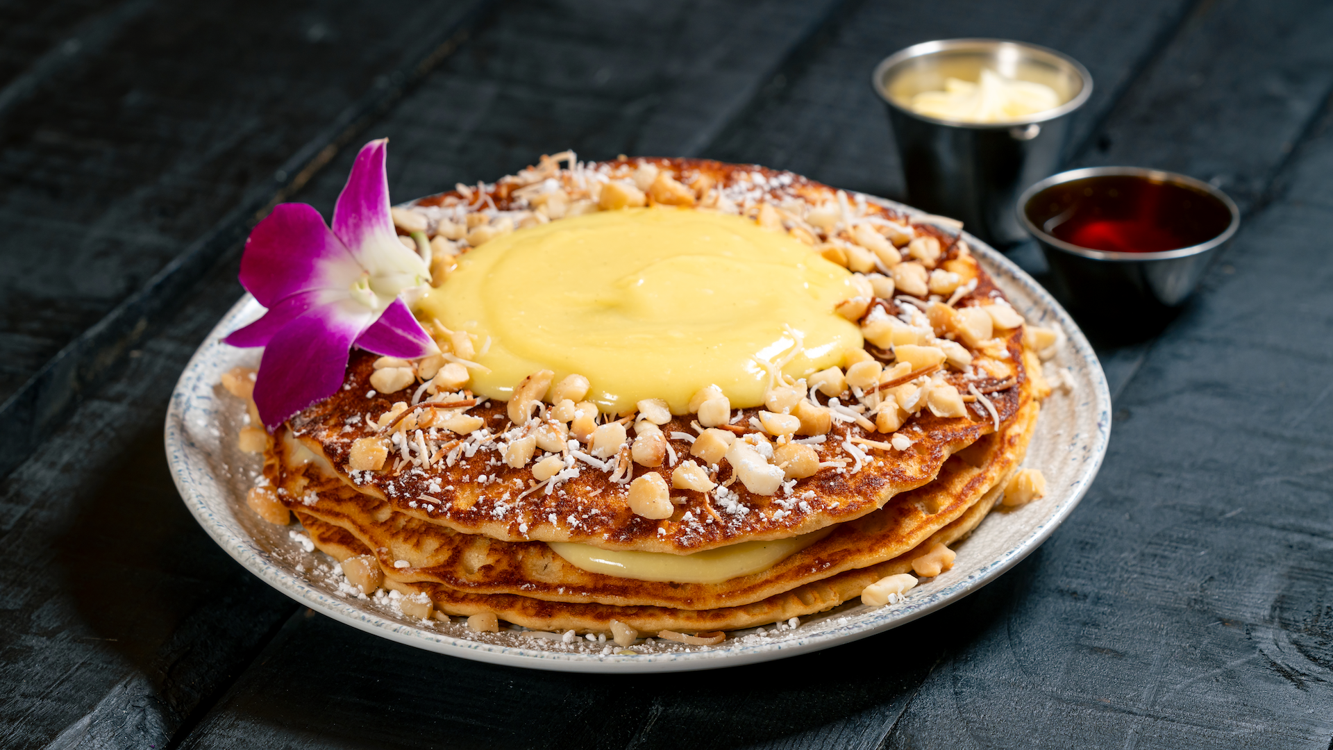 Tropical Pancakes at Trader Sam's: macadamia nut buttermilk pancakes topped with passion fruit curd and toasted coconut