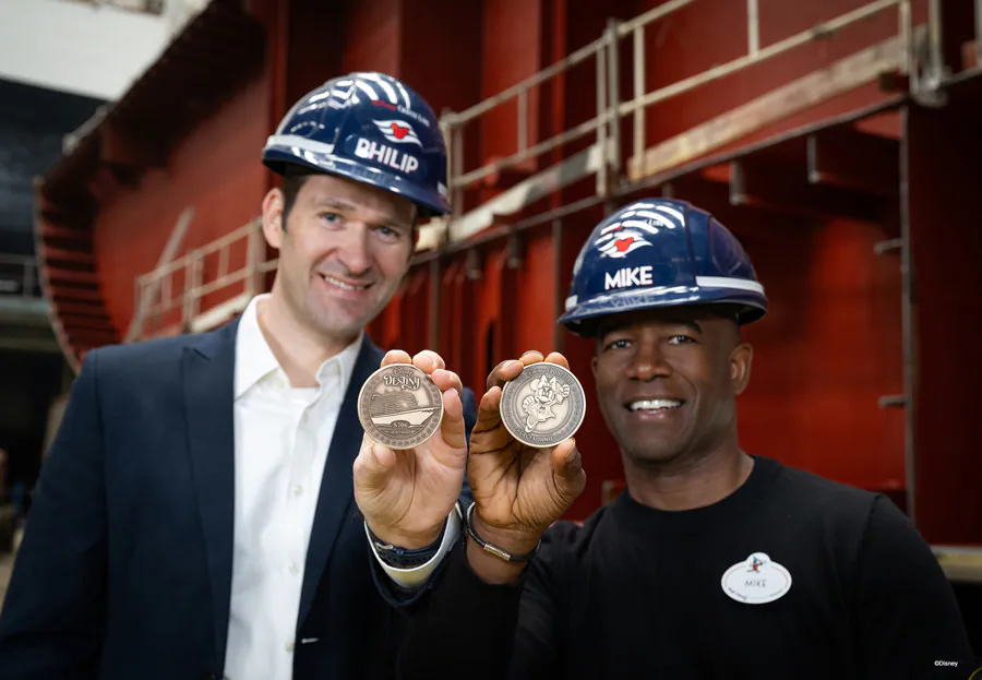 Representatives holding keel coins in front of the Disney Destiny at Meyer Werft