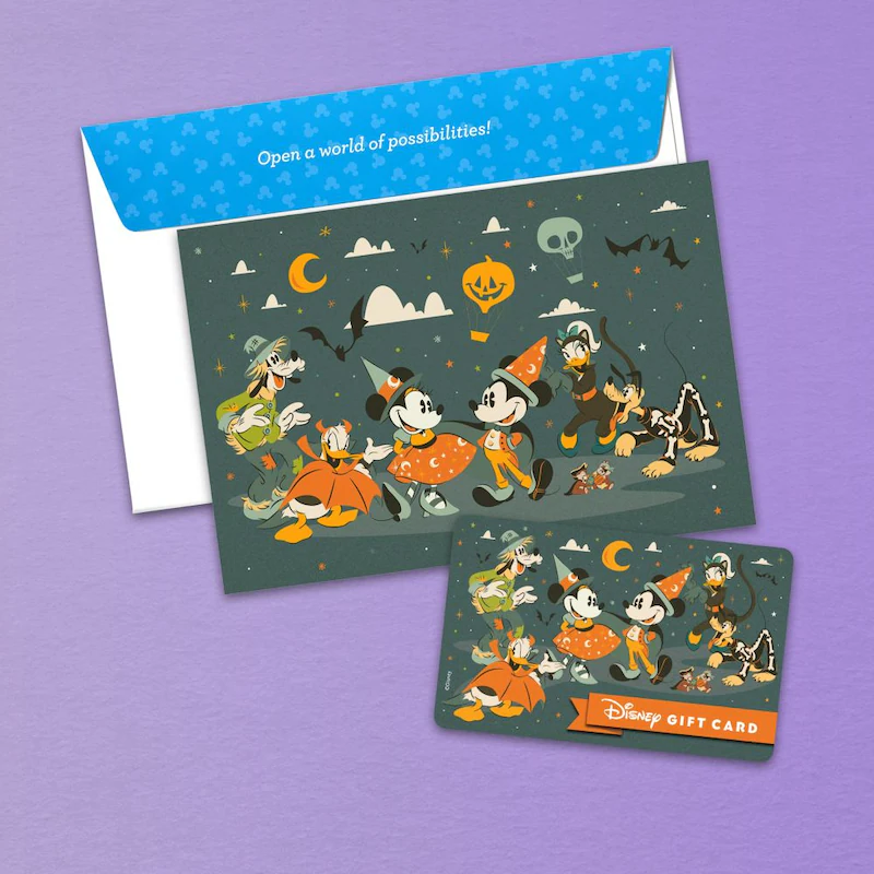 A Halloween-themed Disney Gift Card featuring Mickey Mouse and Minnie Mouse in Halloween costumes, with a matching note card and envelope