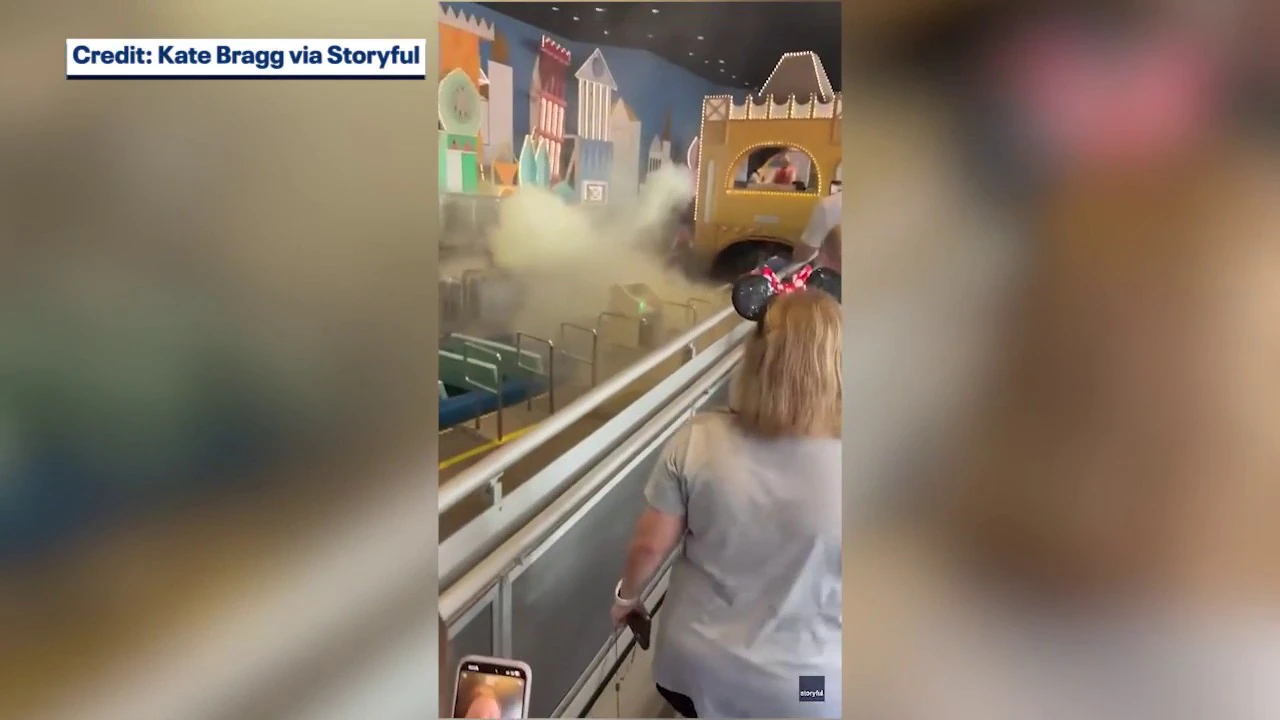 Smoke and extinguisher haze linger over the boats at Walt Disney World's it's a small world after a guest's portable charger caught fire