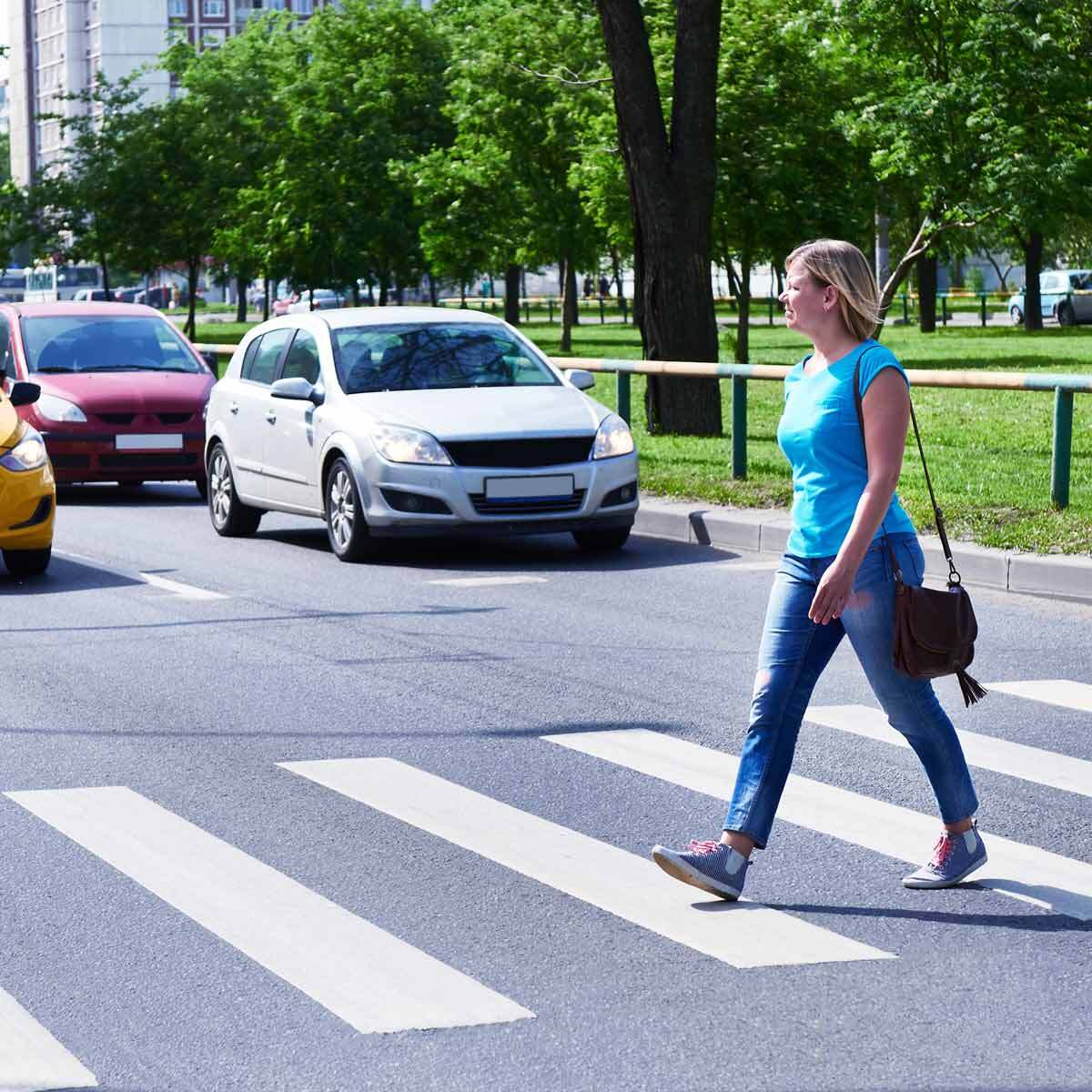 Woman crossing the road at a crosswalk