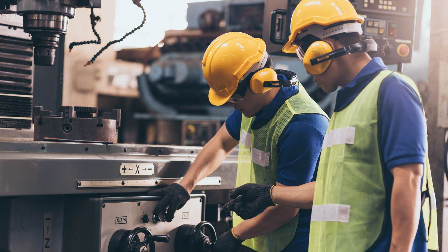 two individuals wearing hard hat working