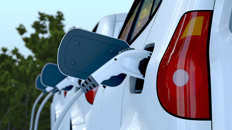White electric vehicle being charged