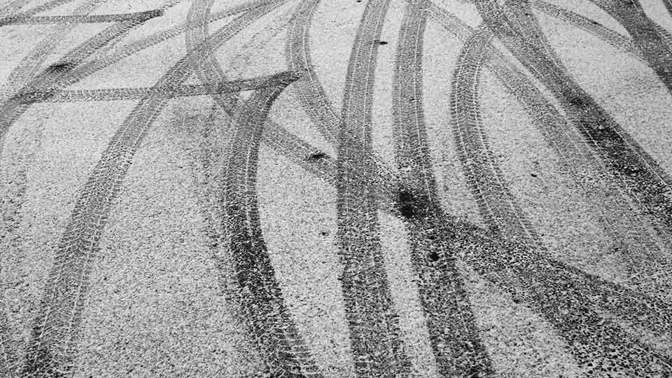 Tire tracks on road in snow