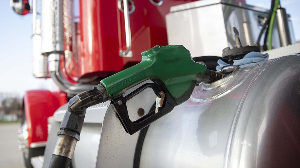 A fuel nozzle filling a truck 