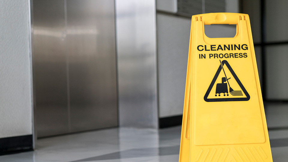 Image of a wet floor sign with "cleaning in progress" on it