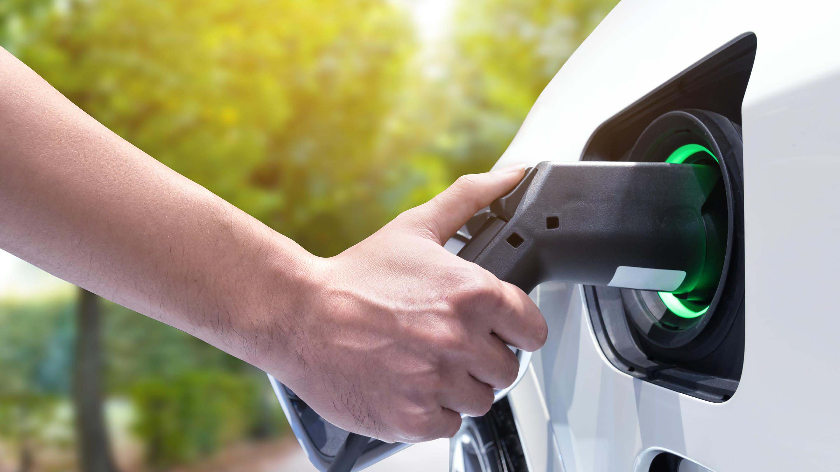 Person charging their electric vehicle