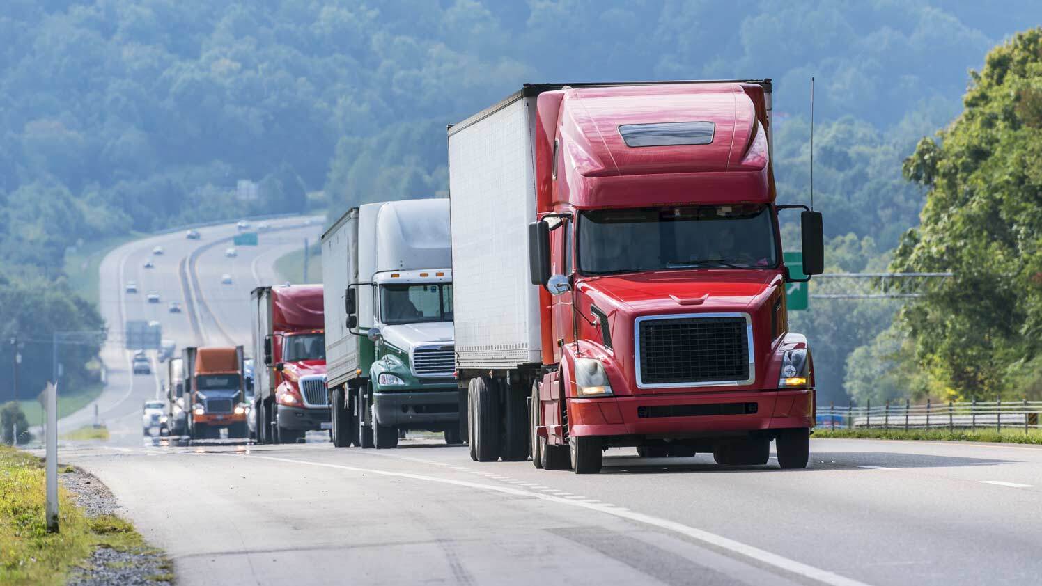 Fleet of trucks driving on the highway