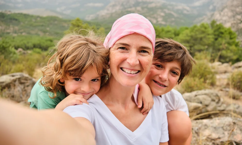 Mujer con cáncer contenta con sus hijos ya que ha cobrado la indemnización
