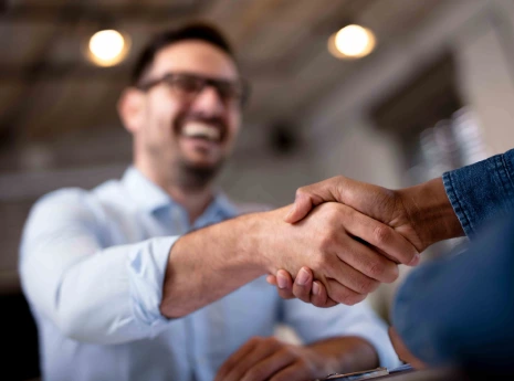 Business partners shaking hands to represent a technology partnership