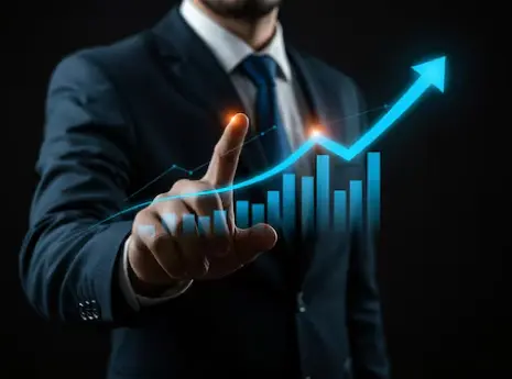 Person reviewing business analytics charts on a laptop while holding a cup of coffee