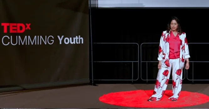 Coach Jo speaking on the TEDx Cumming Youth stage