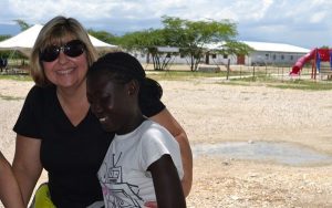 Sobus shares a smile with a girl in Chambrun, Haiti. The Indianapolis-based pediatric physician believes that the key to improving medical care in Haiti is to help local medical providers become as self-sufficient as possible