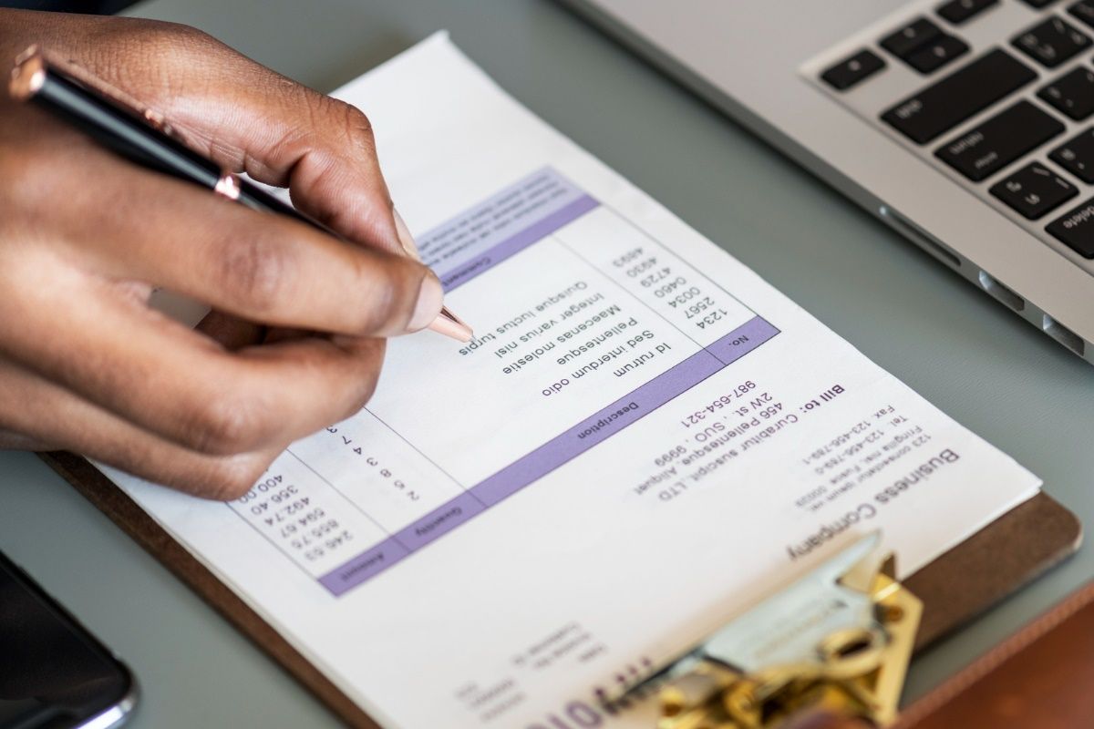 closeup-business-man-checking-tax-invoice-paper