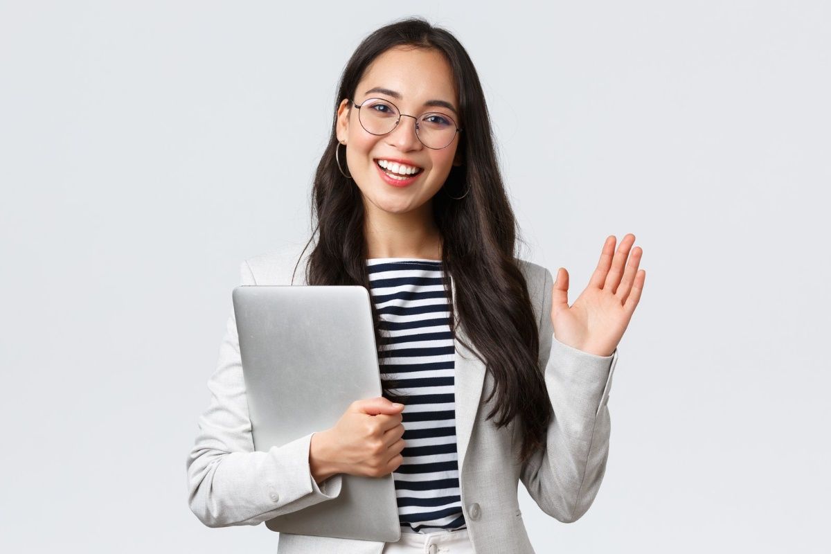 business-finance-employment-female-successful-entrepreneurs-concept-friendly-smiling-office-manager-greeting-new-coworker-businesswoman-welcome-clients-with-hand-wave-hold-laptop