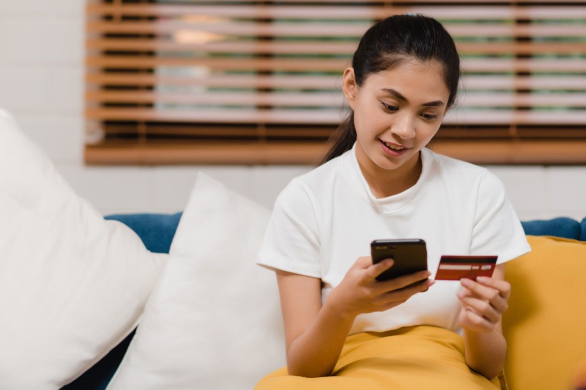 young-smiling-asian-woman-using-smartphone-buying-online-shopping