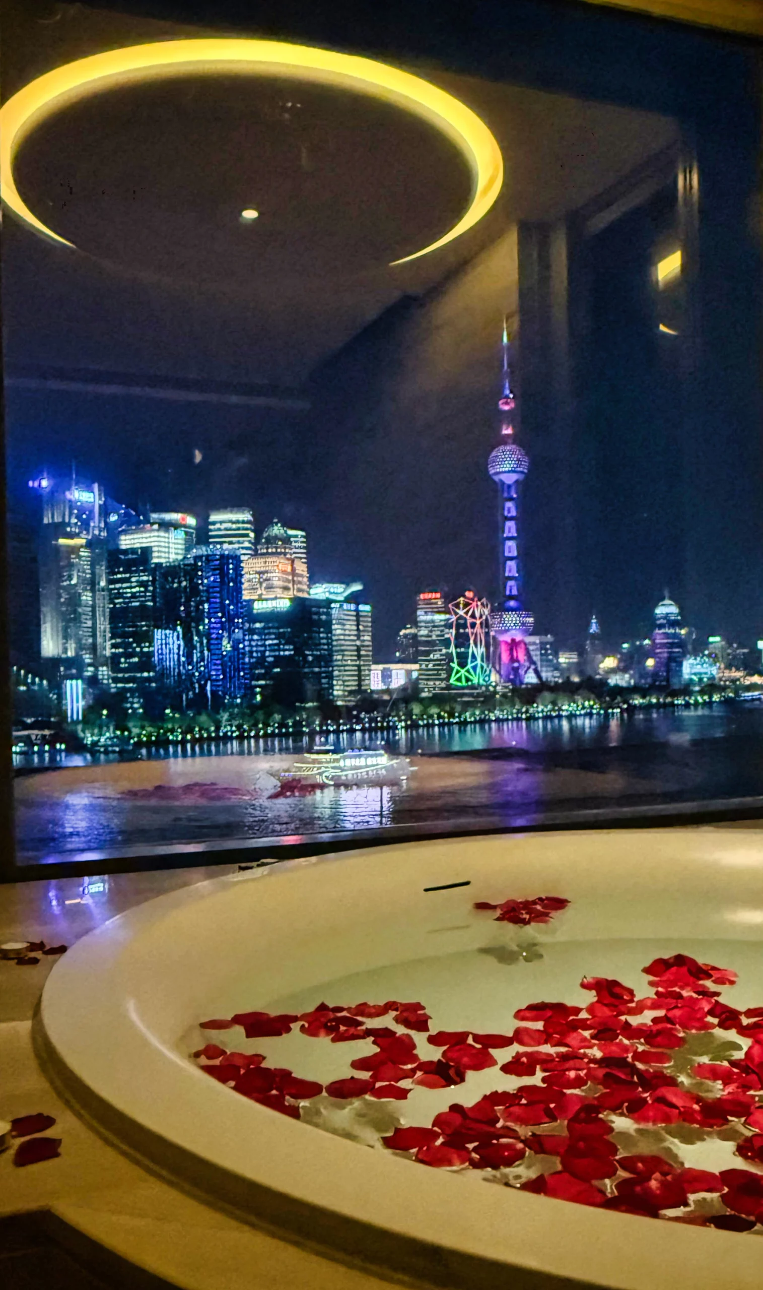 Romantic bath setup with candles and rose petals