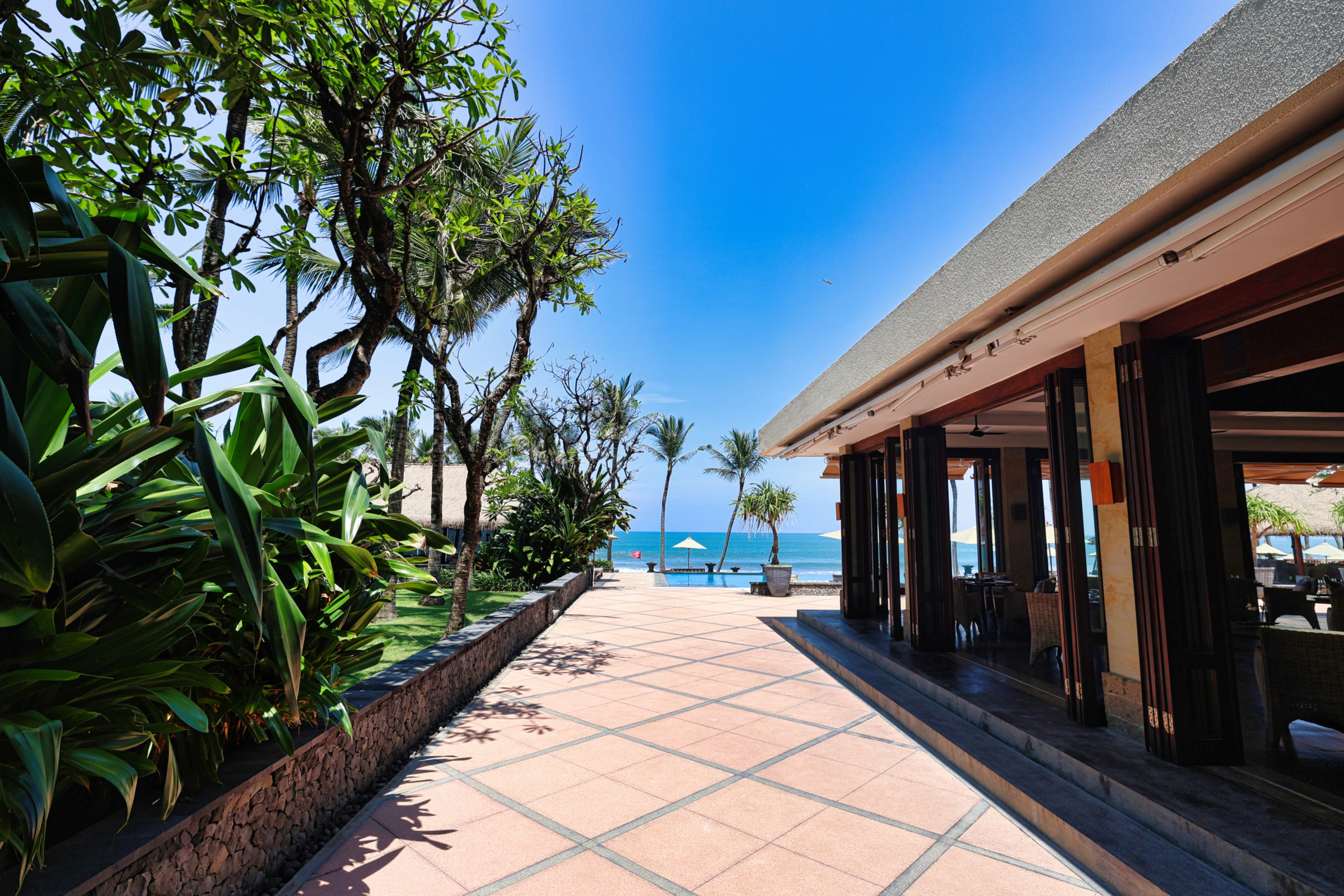 View of the infinity pool merging with Seminyak Beach