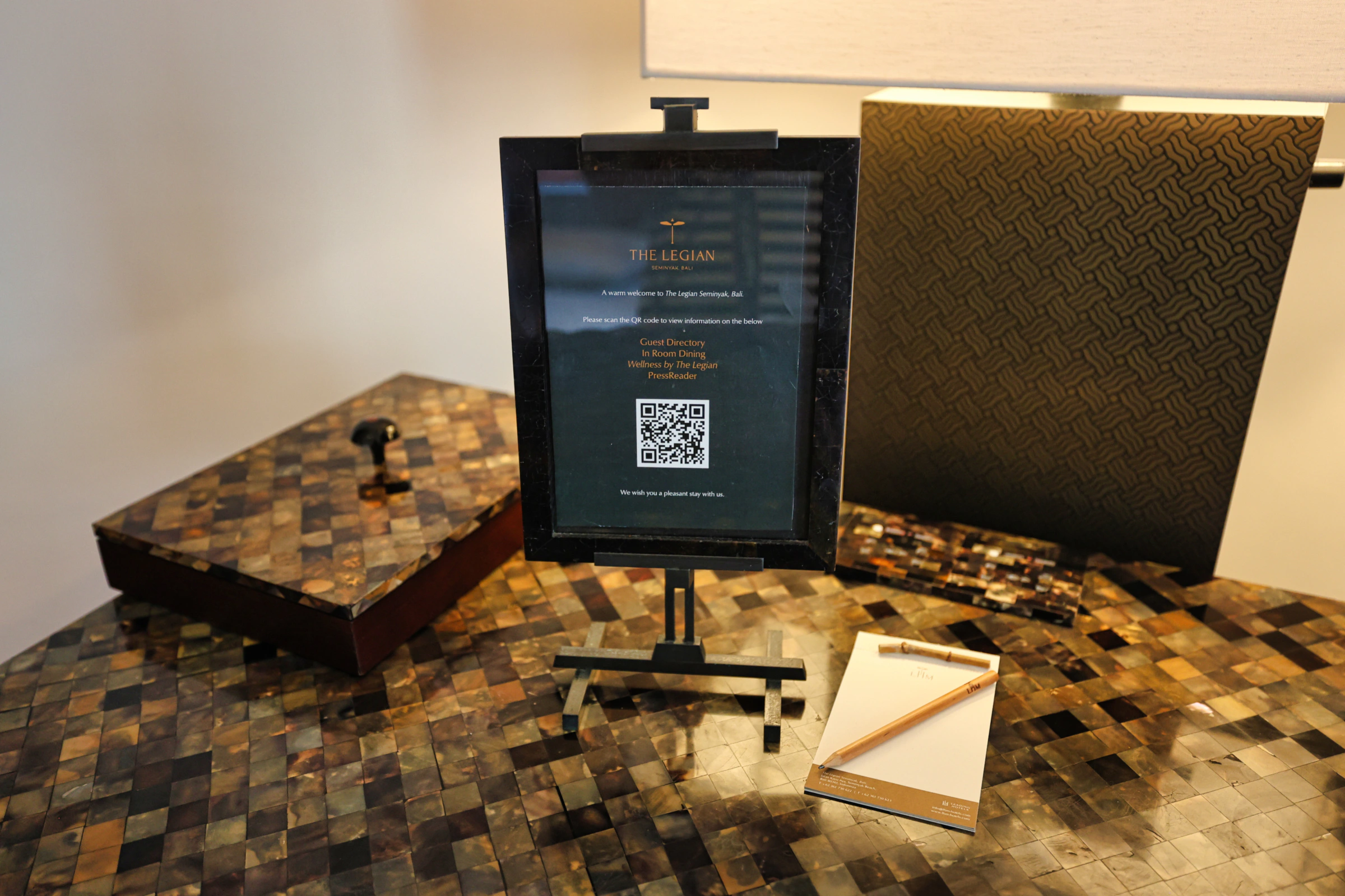 Desk area in hotel suite with information QR code