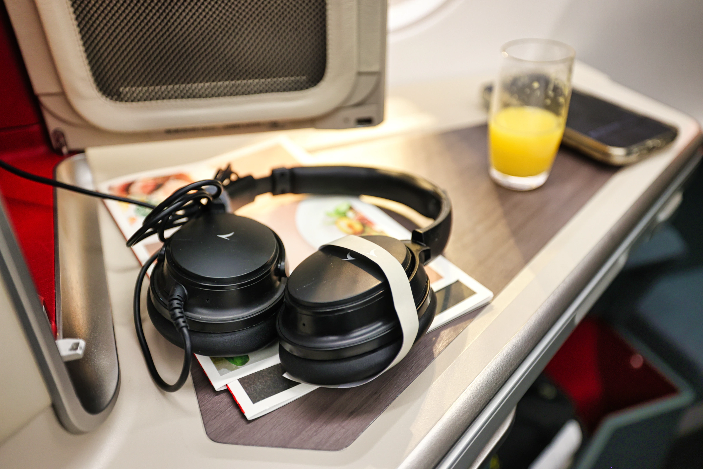 Evian water bottle and headset on an airplane seat