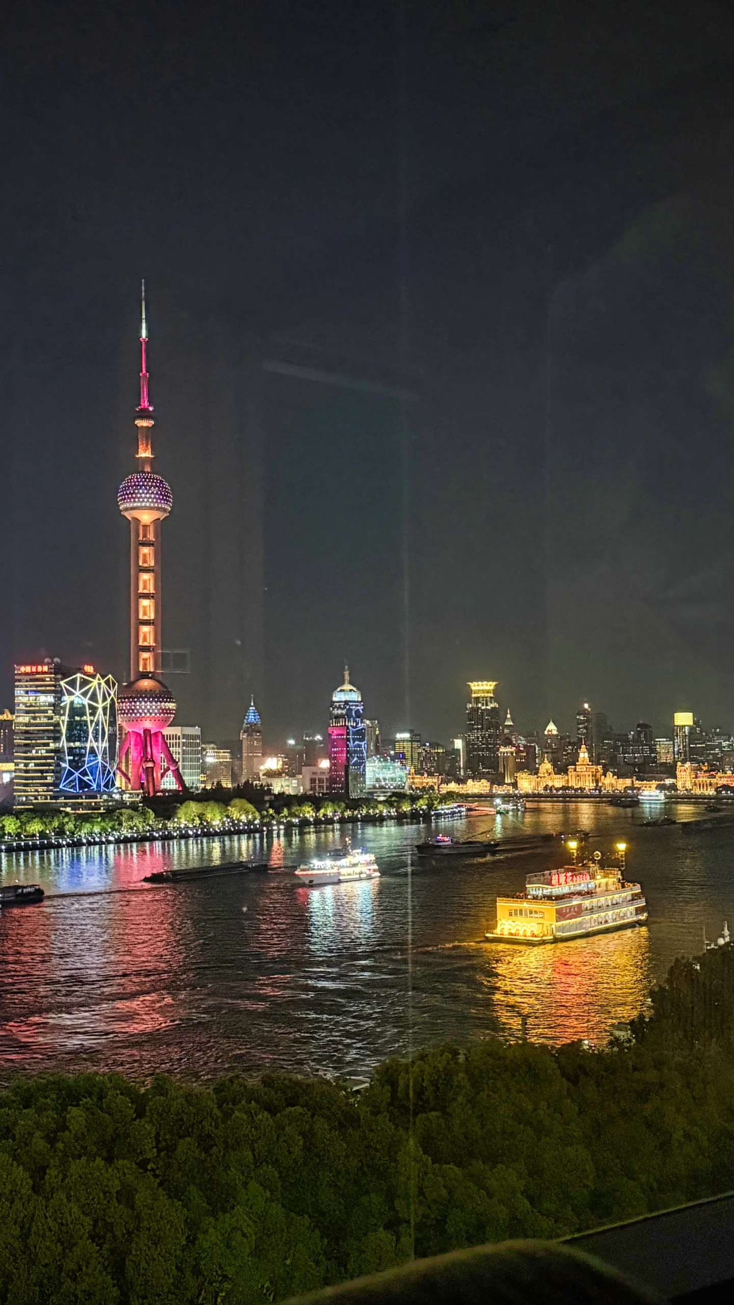 Colorful river cruise boats passing by at night