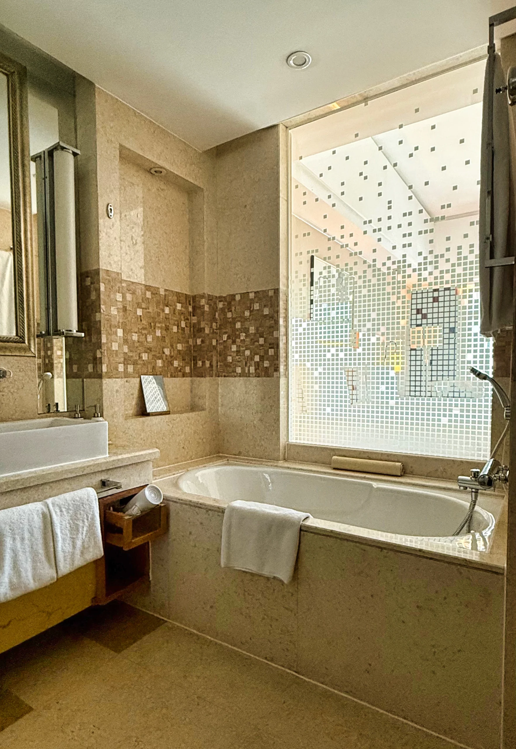 Separate shower and bathtub in a hotel bathroom