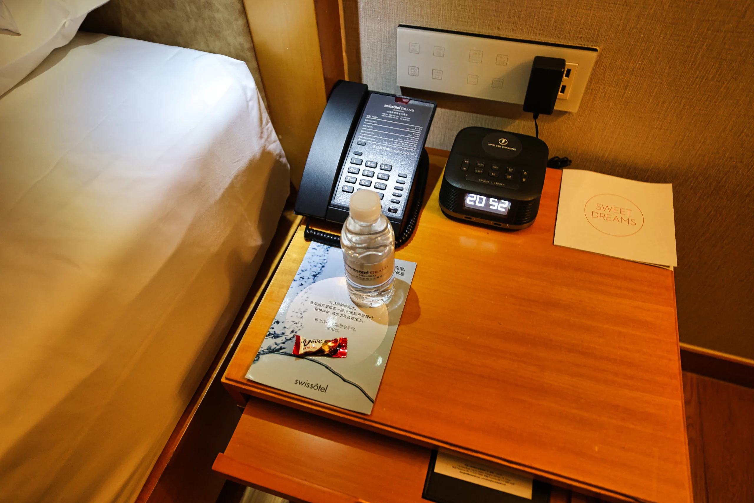 Bedside table with water and chocolate after turndown service