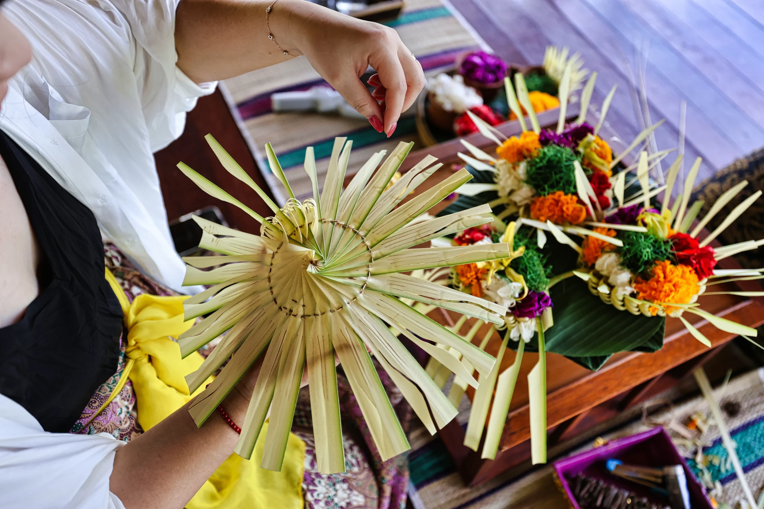 Preparing canang offerings for blessing ceremony