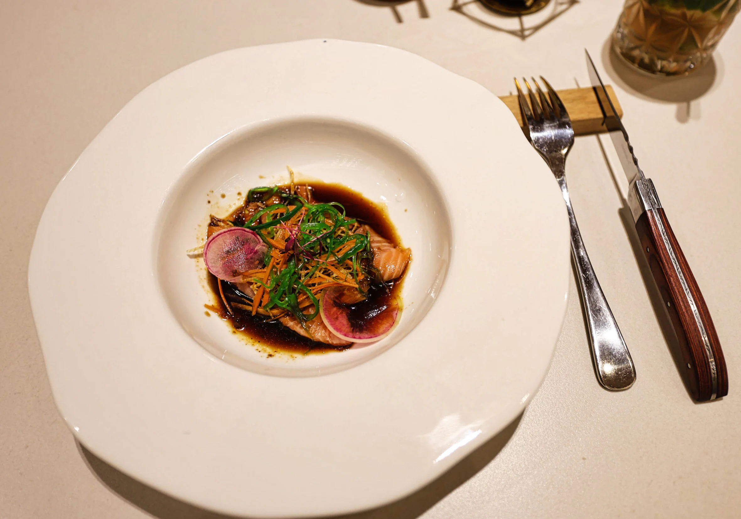 Salmon crudo with poached carrot and caper berries