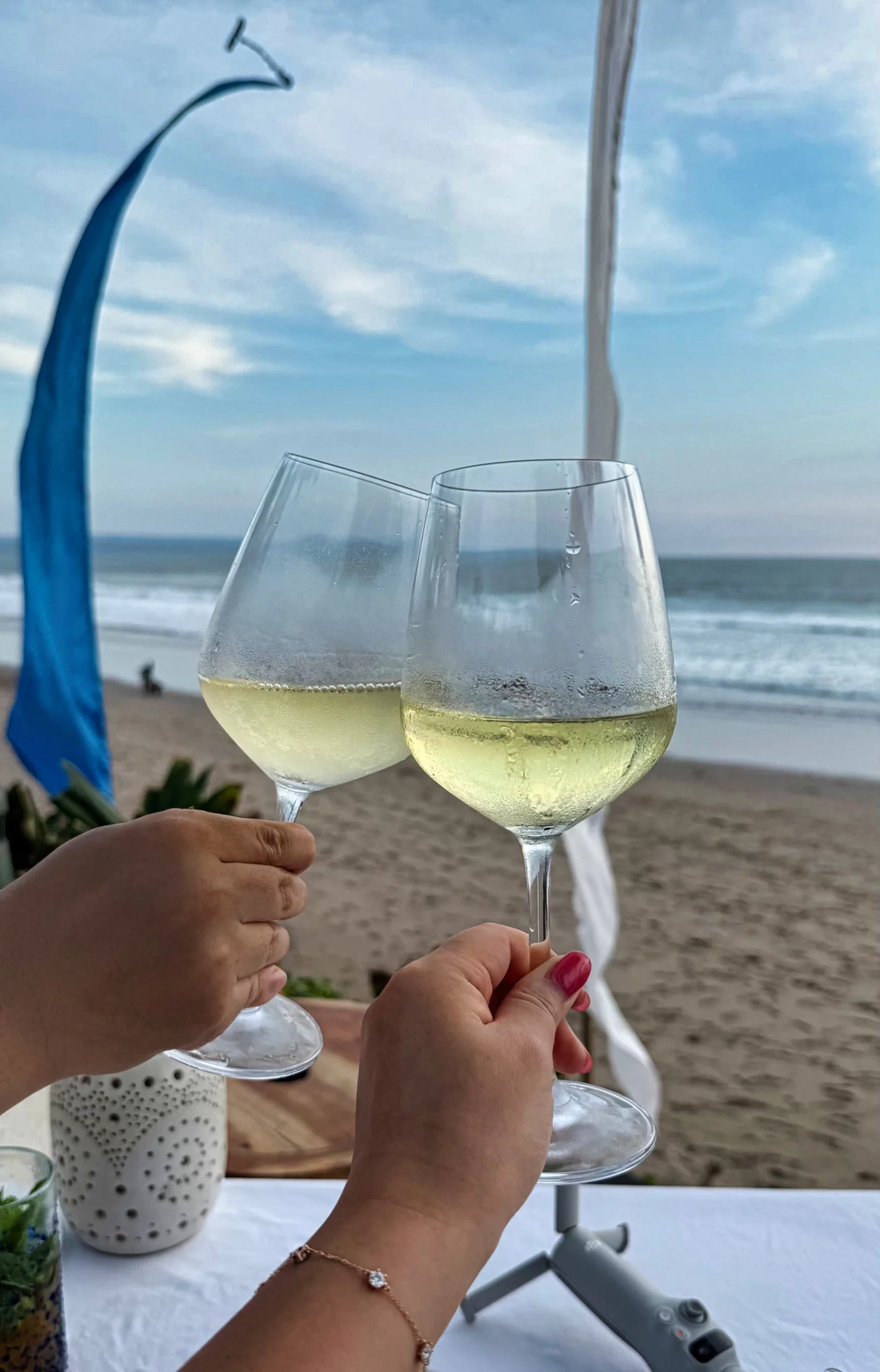 Glass of white wine against a sunset backdrop